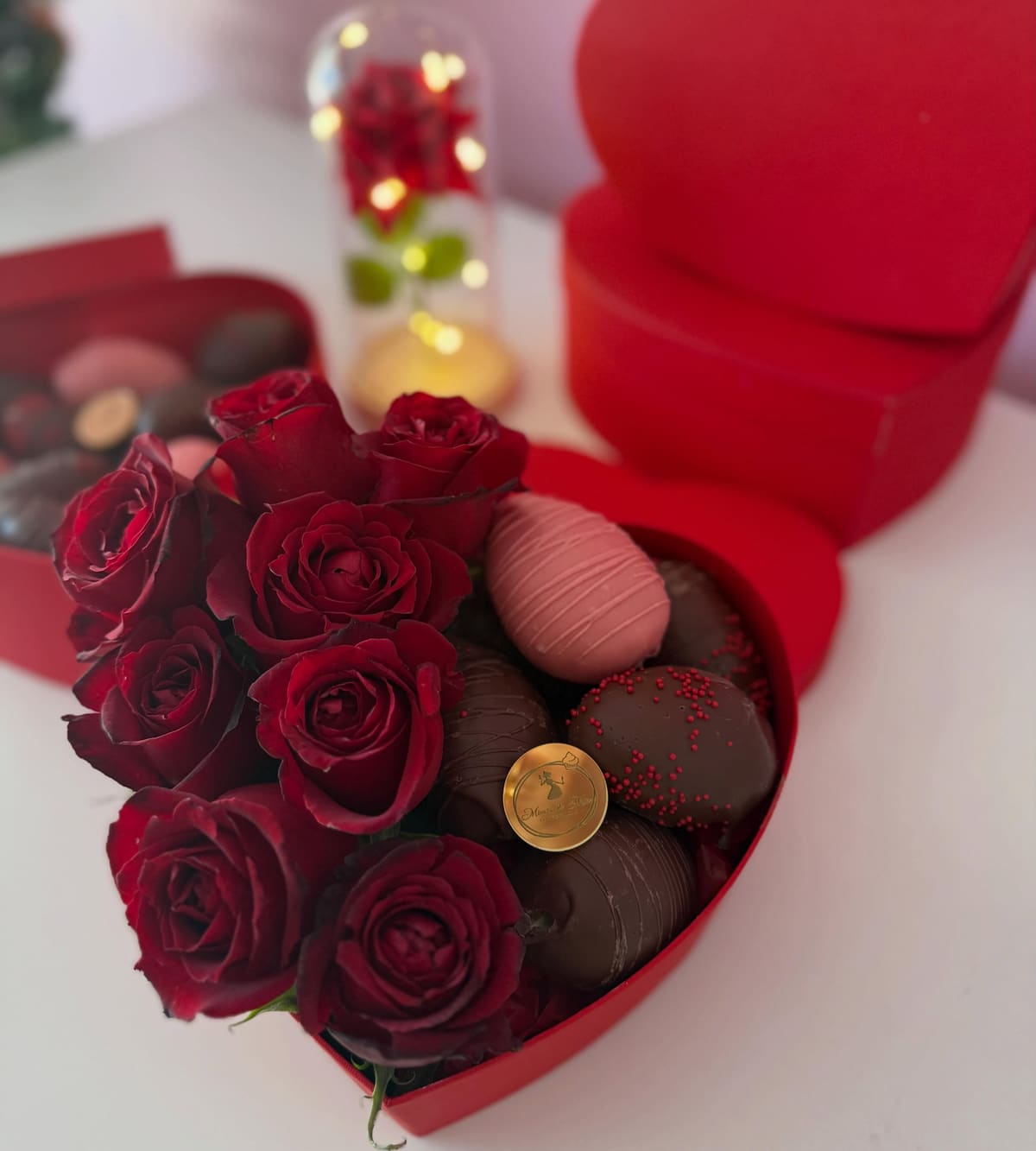 Caixa-coração com rosas vermelhas e morangos cobertos com chocolate